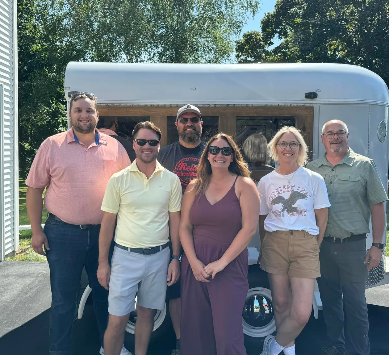 The owners of Door County Mobile Bar in front of their mobile bar trailer